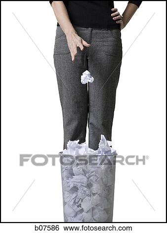 Woman discarding crumpled paper in wastepaper basket View Large Photo Image Stock Photograph - Woman discarding crumpled paper in wastepaper basket. Fotosearch