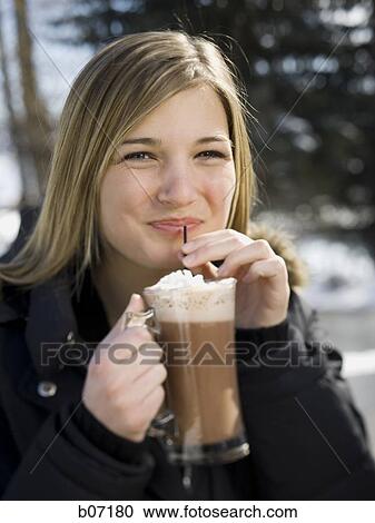 Stock Image - Woman drinking hot chocolate. Fotosearch