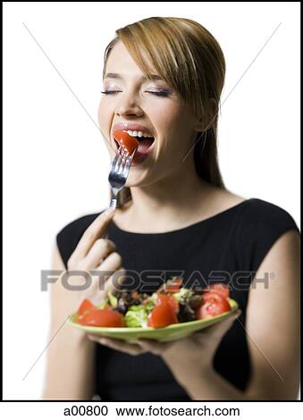 Woman eating healthy plate of food View Large Photo Image Stock Image - Woman eating healthy plate of food. Fotosearch
