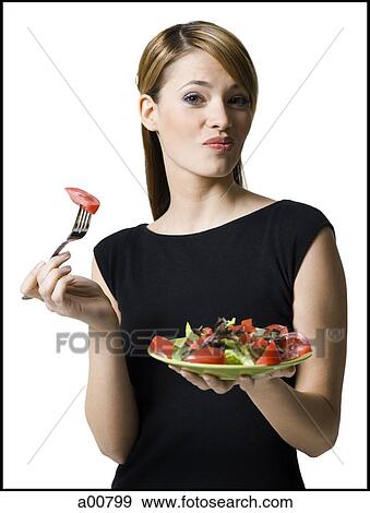 Woman eating healthy plate of food View Large Photo Image Stock Photo - Woman eating healthy plate of food. Fotosearch