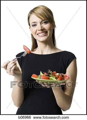 Woman eating healthy plate of food View Large Photo Image Stock Photograph - Woman eating healthy plate of food. Fotosearch