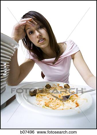 Woman engorging herself on spaghetti View Large Photo Image Stock Photograph - Woman engorging herself on spaghetti. Fotosearch