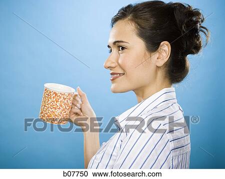 Woman enjoying a mug of coffee View Large Photo Image Stock Image - Woman enjoying a mug of coffee. Fotosearch