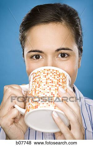 Woman enjoying a mug of coffee View Large Photo Image Stock Photo - Woman enjoying a mug of coffee. Fotosearch