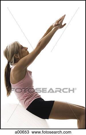 Woman exercising with a pilates ball View Large Photo Image Stock Image - Woman exercising with a pilates ball. Fotosearch