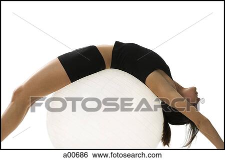 Woman exercising with a pilates ball View Large Photo Image Stock Photograph - Woman exercising with a pilates ball. Fotosearch