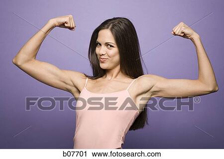 Woman flexing her biceps View Large Photo Image Stock Image - Woman flexing her biceps. Fotosearch