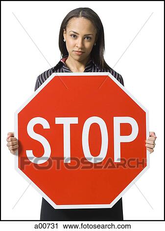 Woman holding a stop sign View Large Photo Image Stock Image - Woman holding a stop sign. Fotosearch