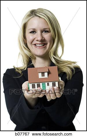 Woman holding a toy house View Large Photo Image Stock Photo - Woman holding a toy house. Fotosearch