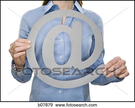 Woman holding an At-sign View Large Photo Image Stock Photo - Woman holding an At-sign. Fotosearch