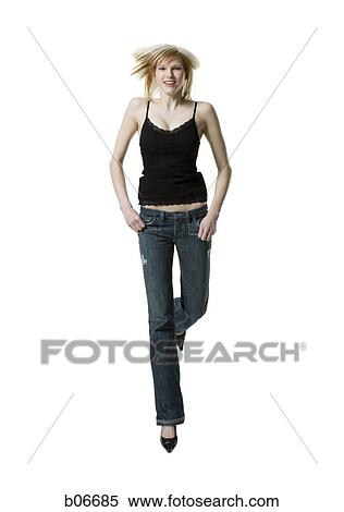 Woman holding pockets and jumping View Large Photo Image Stock Photography - Woman holding pockets and jumping. Fotosearch