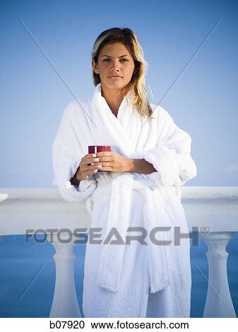 Woman in housecoat relaxing outdoors View Large Photo Image Stock Image - Woman in housecoat relaxing outdoors. Fotosearch