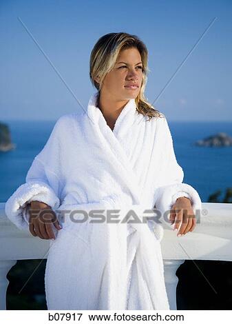 Woman in housecoat relaxing outdoors View Large Photo Image Stock Photo - Woman in housecoat relaxing outdoors. Fotosearch