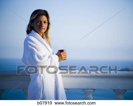 Stock Photo - Woman in housecoat relaxing outdoors. Fotosearch