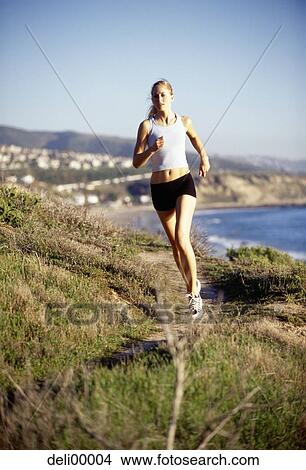 Woman jogging in natural setting View Large Photo Image Picture - Woman jogging in natural setting. Fotosearch