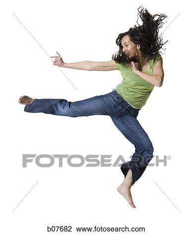 Woman jumping and doing a karate kick View Large Photo Image Stock Image - Woman jumping and doing a karate kick. Fotosearch