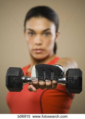 Stock Photography - Woman lifting dumbbell. Fotosearch