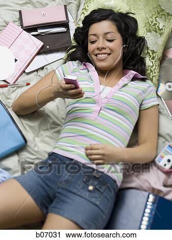 Stock Image - Woman listening to music. Fotosearch