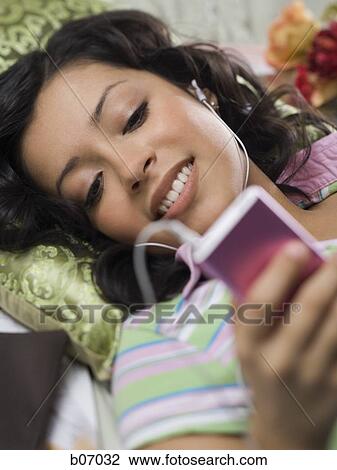 Woman listening to music View Large Photo Image Stock Image - Woman listening to music. Fotosearch