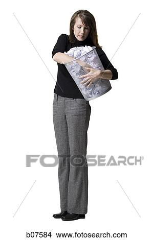 Woman looking through wastepaper basket View Large Photo Image Picture - Woman looking through wastepaper basket. Fotosearch