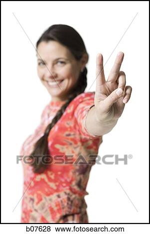 Woman making peace gesture View Large Photo Image Stock Photo - Woman making peace gesture. Fotosearch