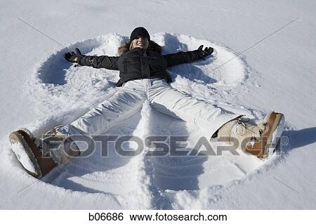 Woman making snow angel View Large Photo Image Stock Photograph - Woman making snow angel. Fotosearch