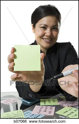 Woman offering marker and blank sticky note View Large Photo Image Stock Photograph - Woman offering marker and blank sticky note. Fotosearch