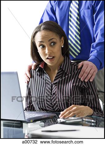 Woman on a laptop with coworker touching shoulders View Large Photo Image Stock Image - Woman on a laptop with coworker touching shoulders. Fotosearch