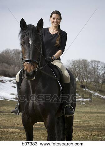 Woman on horseback View Large Photo Image Stock Image - Woman on horseback. Fotosearch