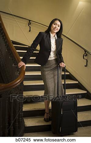 Woman on stairway with luggage View Large Photo Image Stock Photography - Woman on stairway with luggage. Fotosearch