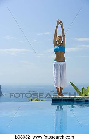 Woman performng yoga exercises by infinity pool View Large Photo Image Stock Image - Woman performng yoga exercises by infinity pool. Fotosearch