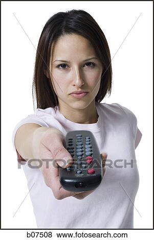 Woman pointing and pressing a handheld remote control View Large Photo Image Stock Photo - Woman pointing and pressing a handheld remote control. Fotosearch