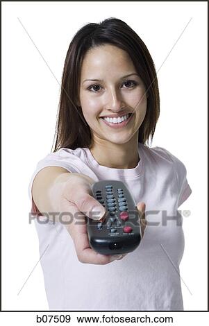 Woman pointing and pressing a handheld remote control View Large Photo Image Stock Photo - Woman pointing and pressing a handheld remote control. Fotosearch