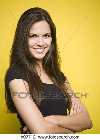 Woman posing with arms folded View Large Photo Image Stock Image - Woman posing with arms folded. Fotosearch