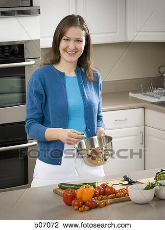 Woman preparing vegetables in kitchen View Large Photo Image Stock Image - Woman preparing vegetables in kitchen. Fotosearch