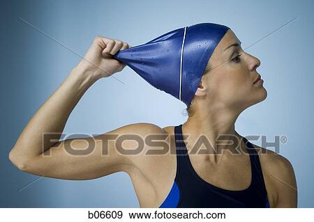 Woman pulling off bathing cap View Large Photo Image Stock Photo - Woman pulling off bathing cap. Fotosearch