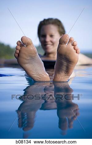 Woman relaxing in infinity pool View Large Photo Image Picture - Woman relaxing in infinity pool. Fotosearch