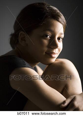 Woman resting chin on knee View Large Photo Image Stock Image - Woman resting chin on knee. Fotosearch