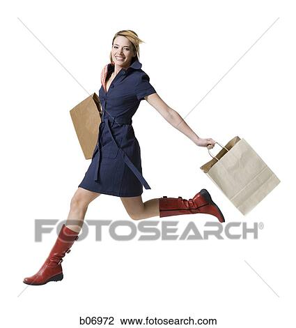 Woman running with shopping bags View Large Photo Image Stock Image - Woman running with shopping bags. Fotosearch