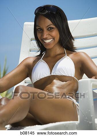 Woman sitting on deck lounger View Large Photo Image Stock Photography - Woman sitting on deck lounger. Fotosearch