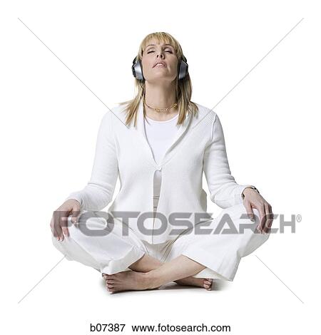 Woman sitting with headphones View Large Photo Image Stock Photo - Woman sitting with headphones. Fotosearch