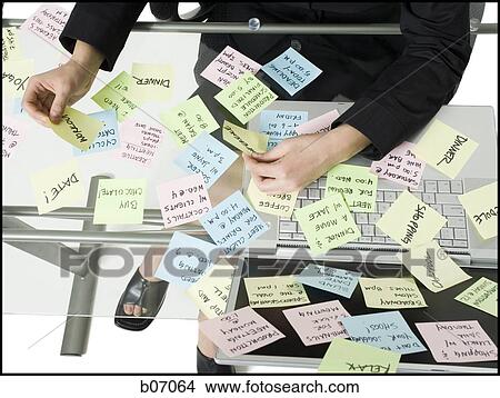 Woman sorting sticky notes View Large Photo Image Picture - Woman sorting sticky notes. Fotosearch