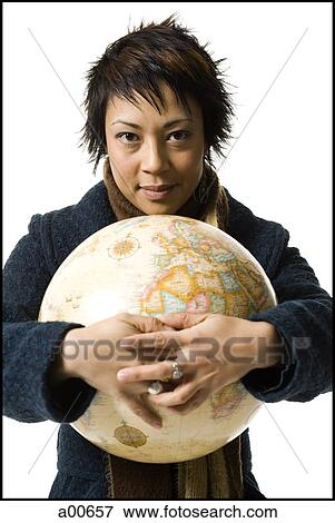 Woman standing with a globe View Large Photo Image Stock Photo - Woman standing with a globe. Fotosearch