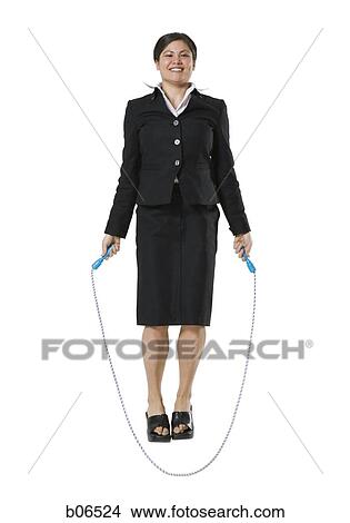 Picture - Woman standing with skipping rope. Fotosearch