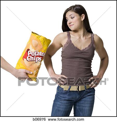 Woman tempted by potato chips View Large Photo Image Stock Photograph - Woman tempted by potato chips. Fotosearch