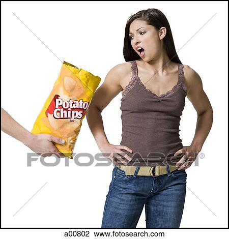 Woman upset by potato chips View Large Photo Image Stock Image - Woman upset by potato chips. Fotosearch