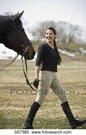 Woman walking with horse View Large Photo Image Stock Photography - Woman walking with horse. Fotosearch