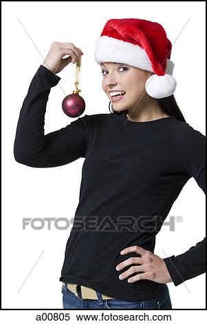 Woman with christmas ornament and santa hat View Large Photo Image Stock Photography - Woman with christmas ornament and santa hat. Fotosearch