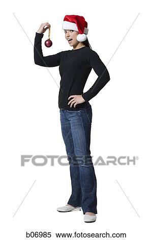 Woman with christmas ornament and santa hat View Large Photo Image Stock Photography - Woman with christmas ornament and santa hat. Fotosearch