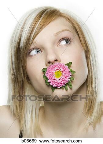 Woman with flower blossom in mouth View Large Photo Image Stock Photo - Woman with flower blossom in mouth. Fotosearch